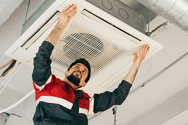 Technicians with AC unit