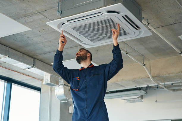 AC technician working on outdoor unit
